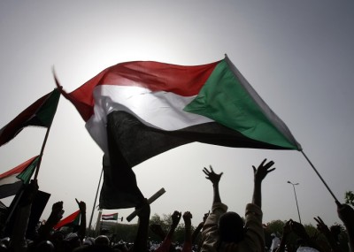 Sudanese wave national flags as they gather outside the Defence Ministry in the capital Khartoum on April 20, 2012 to celebrate retaking the oil town of Heglig from South Sudanese forces. Border clashes between Sudan and South Sudan escalated last week with waves of air strikes hitting the South, and Juba seizing the north's Heglig oil hub on April 10. AFP PHOTO/ASHRAF SHAZLY (Photo credit should read ASHRAF SHAZLY/AFP/Getty Images)