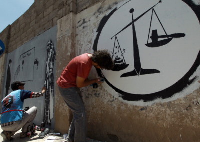 Yemeni artists finish graffitis against corruption in Yemen on a wall in the capital Sanaa on June 5, 2014. AFP PHOTO / MOHAMMED HUWAIS        (Photo credit should read MOHAMMED HUWAIS/AFP/Getty Images)
