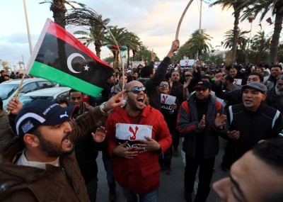 Libyan protestors hold placards as they demonstrate against the extended mandate of the General National Congress, the country's highest political authority, in Tripoli's Martyr square, on December 27, 2013. AFP PHOTO/MAHMUD TURKIA        (Photo credit should read MAHMUD TURKIA/AFP/Getty Images)